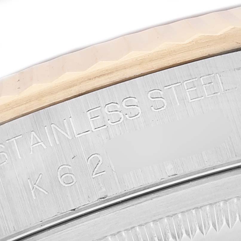 This close-up image shows the stainless steel case back and part of the textured bezel of the Rolex Datejust 16233 Men's Steel and Gold (two tone) Black Dial 16233 Men's Steel and Gold (two tone) Black Dial watch.