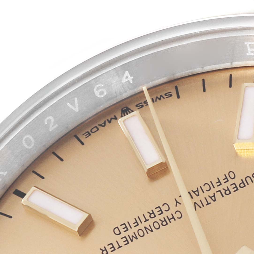 This close-up image shows the upper right quarter of the dial and the edge of the bezel of the Rolex Datejust 126203 Men's Steel and Gold (two tone) Champagne Dial 126203 Men's Steel and Gold (two tone) Champagne Dial watch.