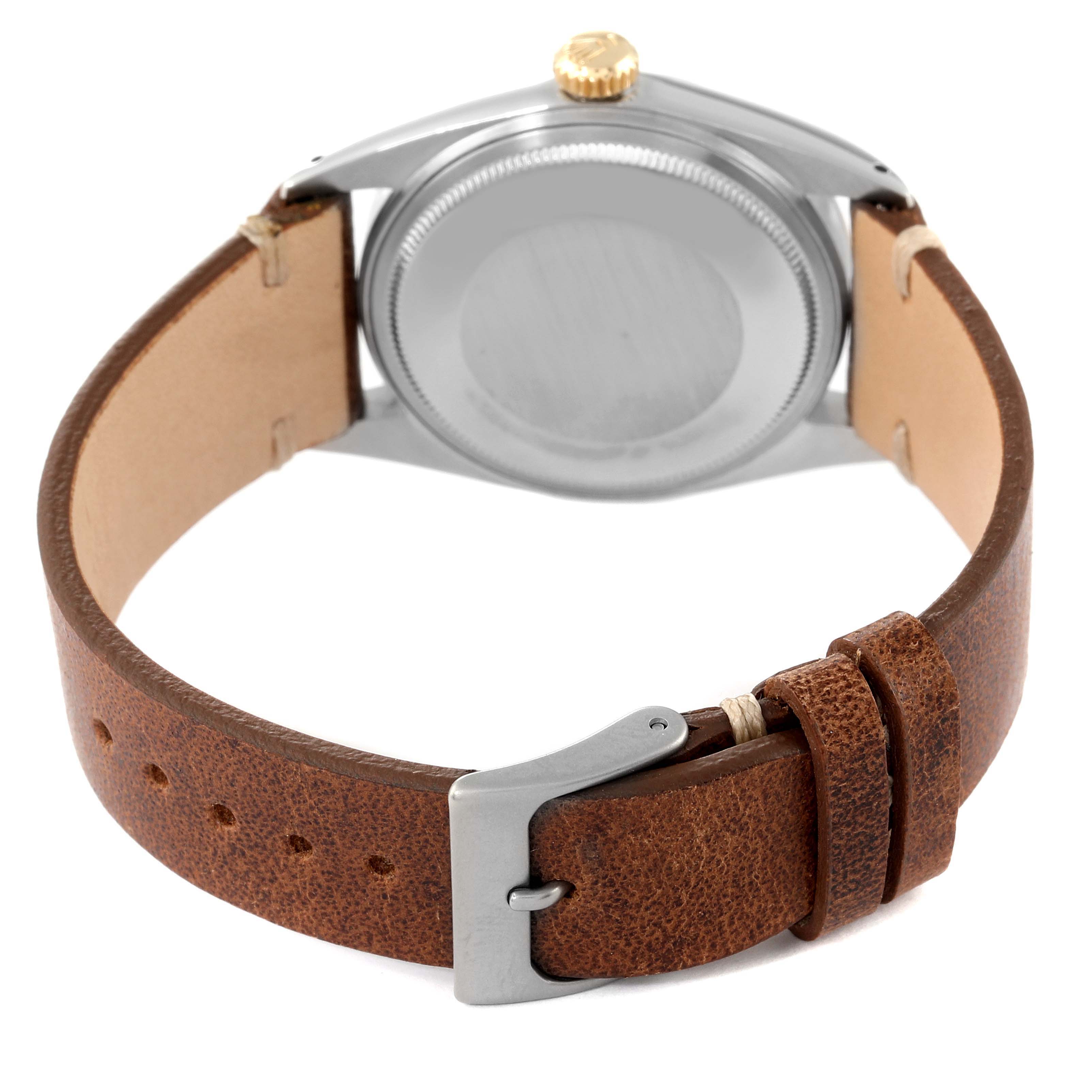 This image shows the back view of a Rolex Datejust 1601 Men's Steel and Gold (two tone) Champagne Dial 1601 Men's Steel and Gold (two tone) Champagne Dial watch with a brown leather strap and buckle.