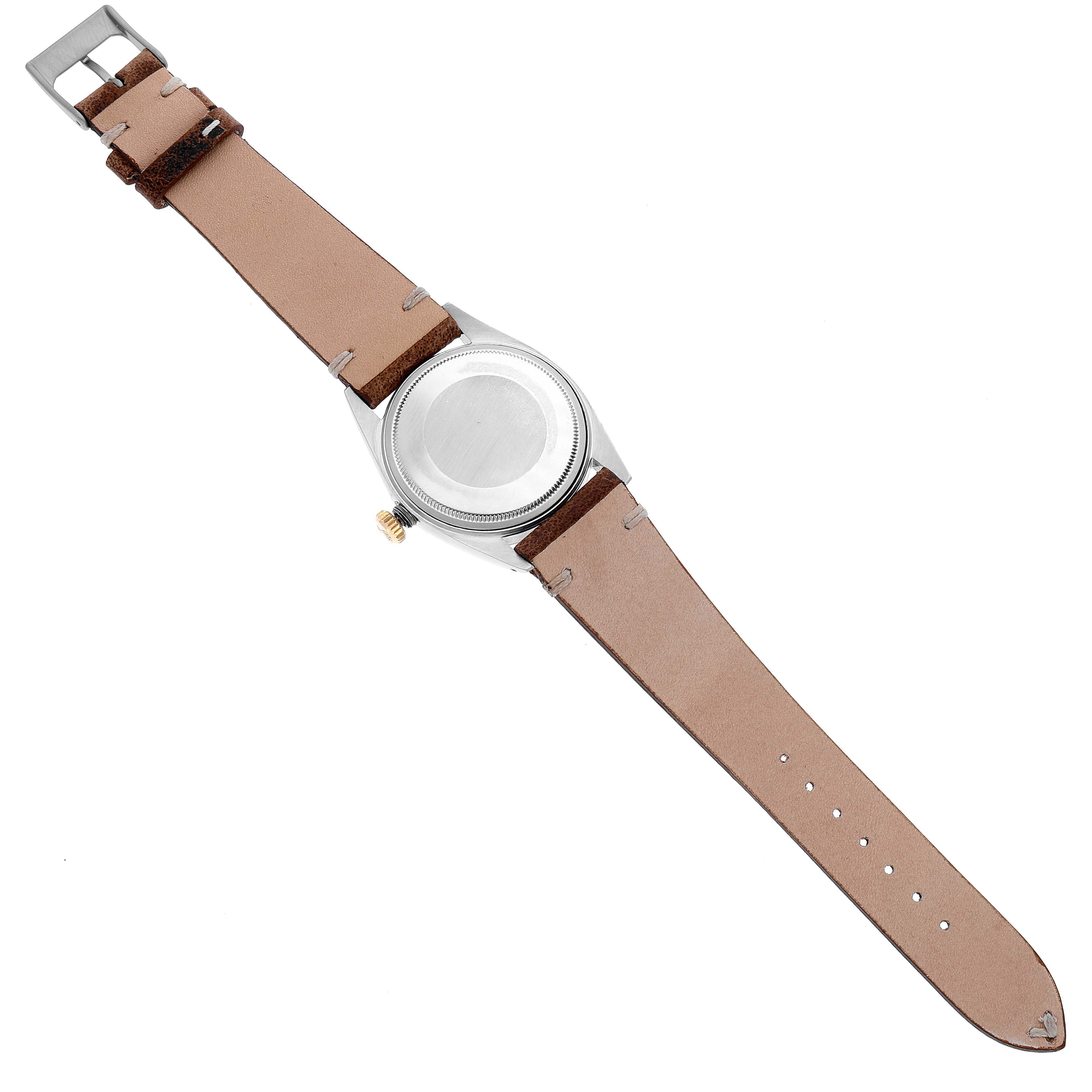 The image shows the back view of a Rolex Datejust 1601 Men's Steel and Gold (two tone) Champagne Dial 1601 Men's Steel and Gold (two tone) Champagne Dial watch with a leather strap fully extended.