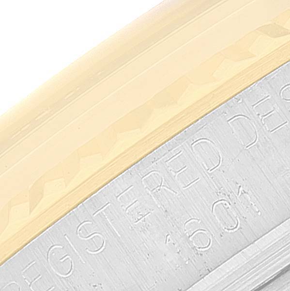 This image shows a close-up view of the engraved edge of a Rolex Datejust 1601 Men's Steel and Gold (two tone) Champagne Dial 1601 Men's Steel and Gold (two tone) Champagne Dial watch case.