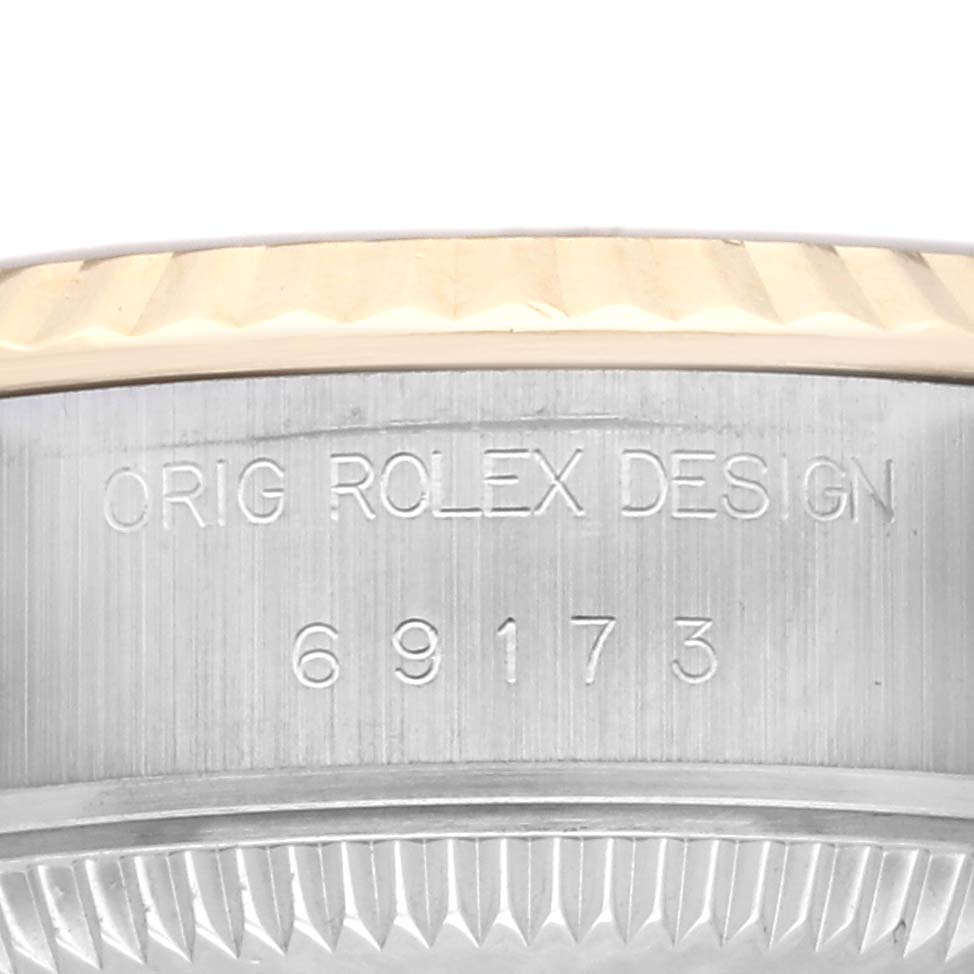 The image shows a close-up of the side of a Rolex Datejust 69173 Women's Steel and Gold (two tone) Champagne Dial 69173 Women's Steel and Gold (two tone) Champagne Dial watch case with engraved model number 69173.