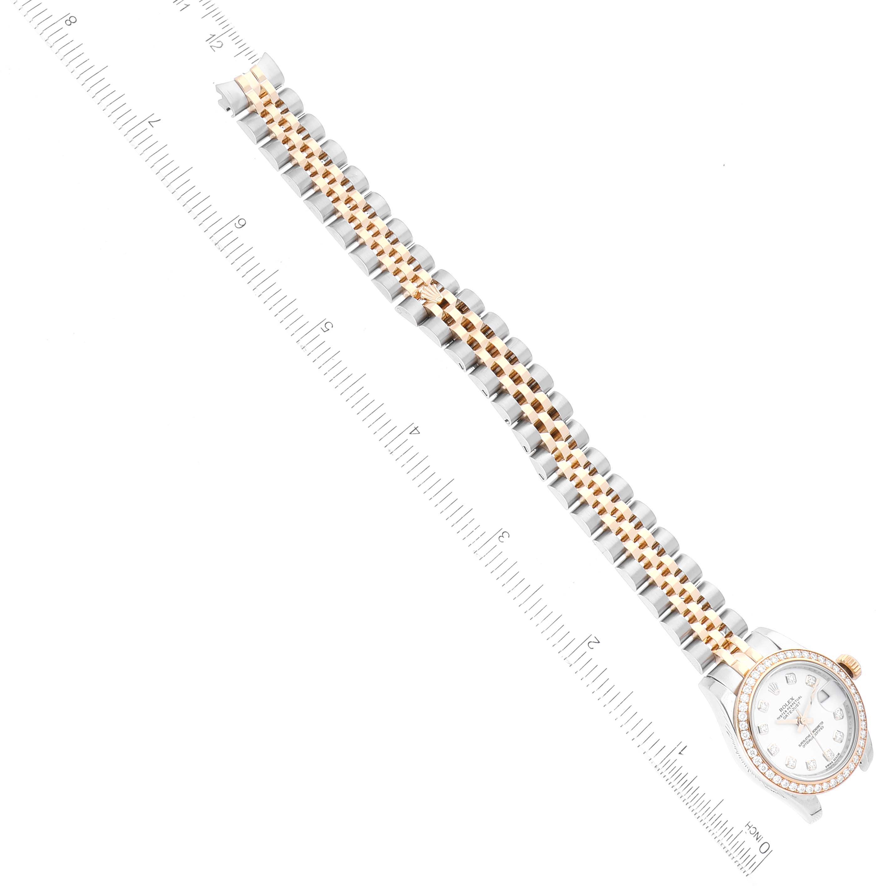 The image shows a Rolex Datejust 179383 Women's Steel and Gold (two tone) White Dial 179383 Women's Steel and Gold (two tone) White Dial watch with a focus on the full bracelet and the face, aligned next to a centimeter ruler.