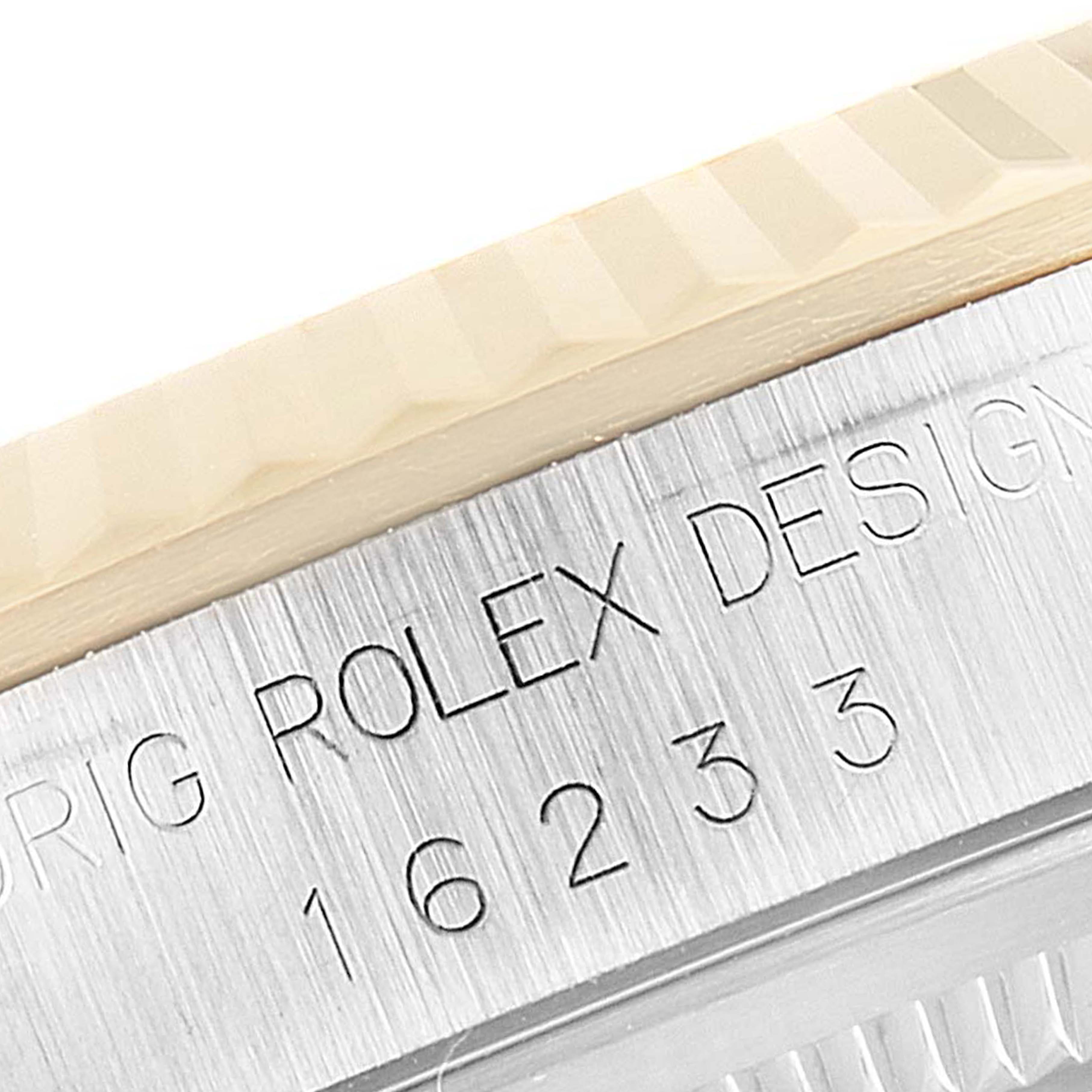 This close-up image shows the side of the bezel and casing with engraved text of the Rolex Datejust 16233 Men
s Steel and Gold (two tone) Grey Dial 16233 Men
s Steel and Gold (two tone) Grey Dial model.