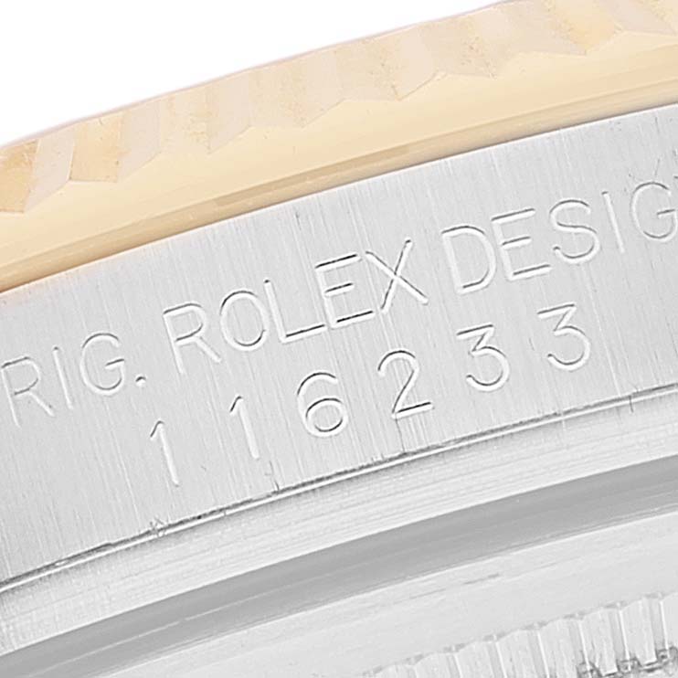 This image shows a close-up of the engraved side of the bezel and case of a Rolex Datejust 116233 Men's Steel and Gold (two tone) Beige Dial 116233 Men's Steel and Gold (two tone) Beige Dial watch.