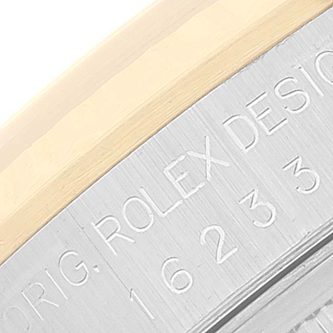 Close-up of the side of the Rolex Datejust 16233 Men's Steel and Gold (two tone) Silver Dial 16233 Men's Steel and Gold (two tone) Silver Dial watch case, showing engraved text and part of the bezel.