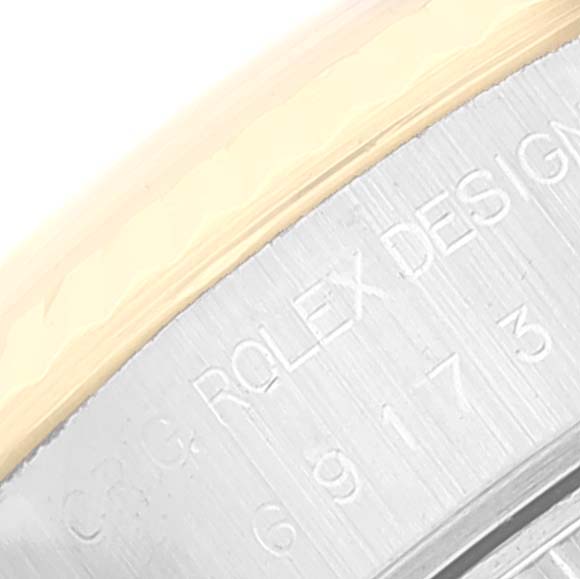 This close-up image shows the engraved inner rim of a Rolex Datejust 69173 Women
s Steel and Gold (two tone) White Dial 69173 Women
s Steel and Gold (two tone) White Dial watch.