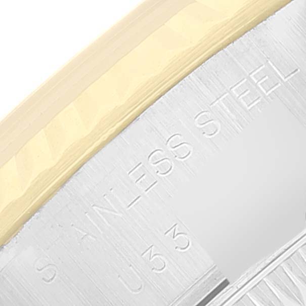 The image shows a close-up of the edge and part of the band of the Rolex Datejust 69173 Women
s Steel and Gold (two tone) White Dial 69173 Women
s Steel and Gold (two tone) White Dial watch, displaying its "STAINLESS STEEL" engraving.