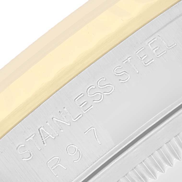 This image shows a close-up of the metal bezel of a Rolex Datejust 16233 Men's Steel and Gold (two tone) White Dial 16233 Men's Steel and Gold (two tone) White Dial watch, highlighting the stainless steel and engraved markings.