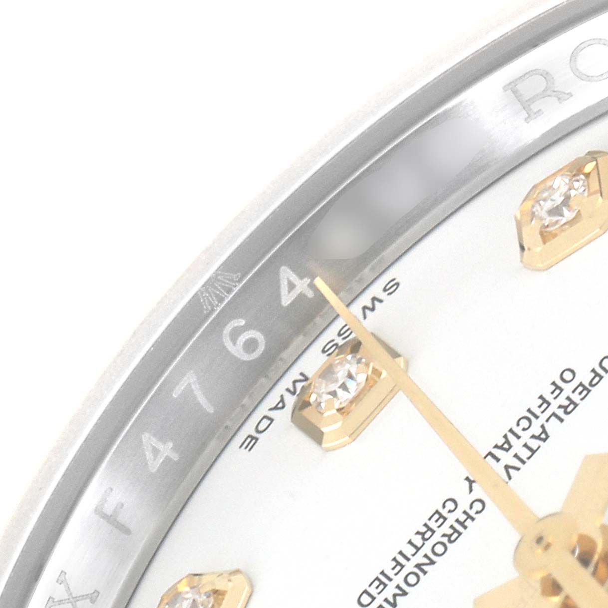The image shows a close-up of the upper right section of the dial and the rehaut of a Rolex Datejust 116233 Men's Steel and Gold (two tone) White Dial 116233 Men's Steel and Gold (two tone) White Dial watch, focusing on the serial number.