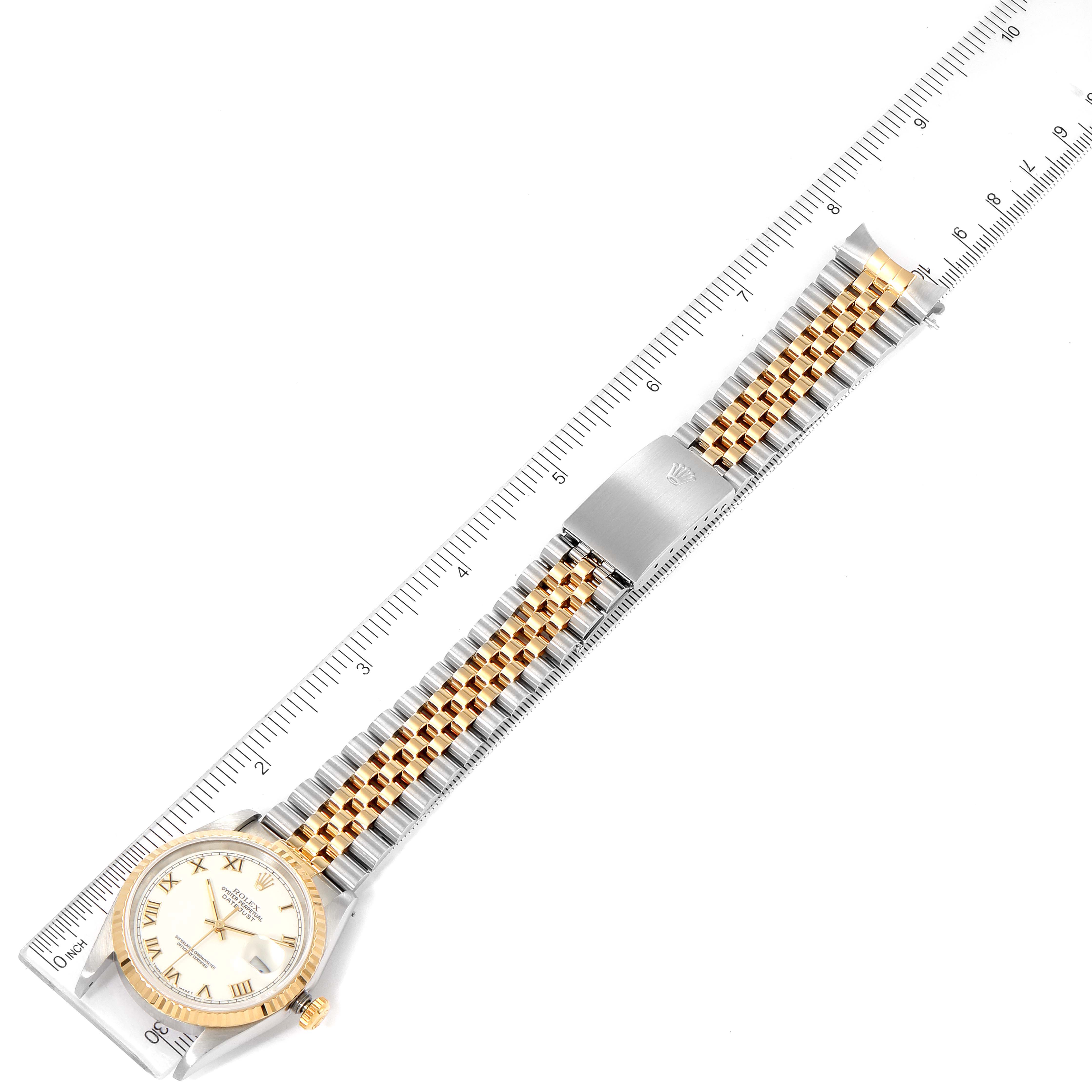 The image shows a Rolex Datejust 16233 Men's Steel and Gold (two tone) White Dial 16233 Men's Steel and Gold (two tone) White Dial watch, angled flat with its dial, bracelet, and clasp visible, alongside a measuring ruler.