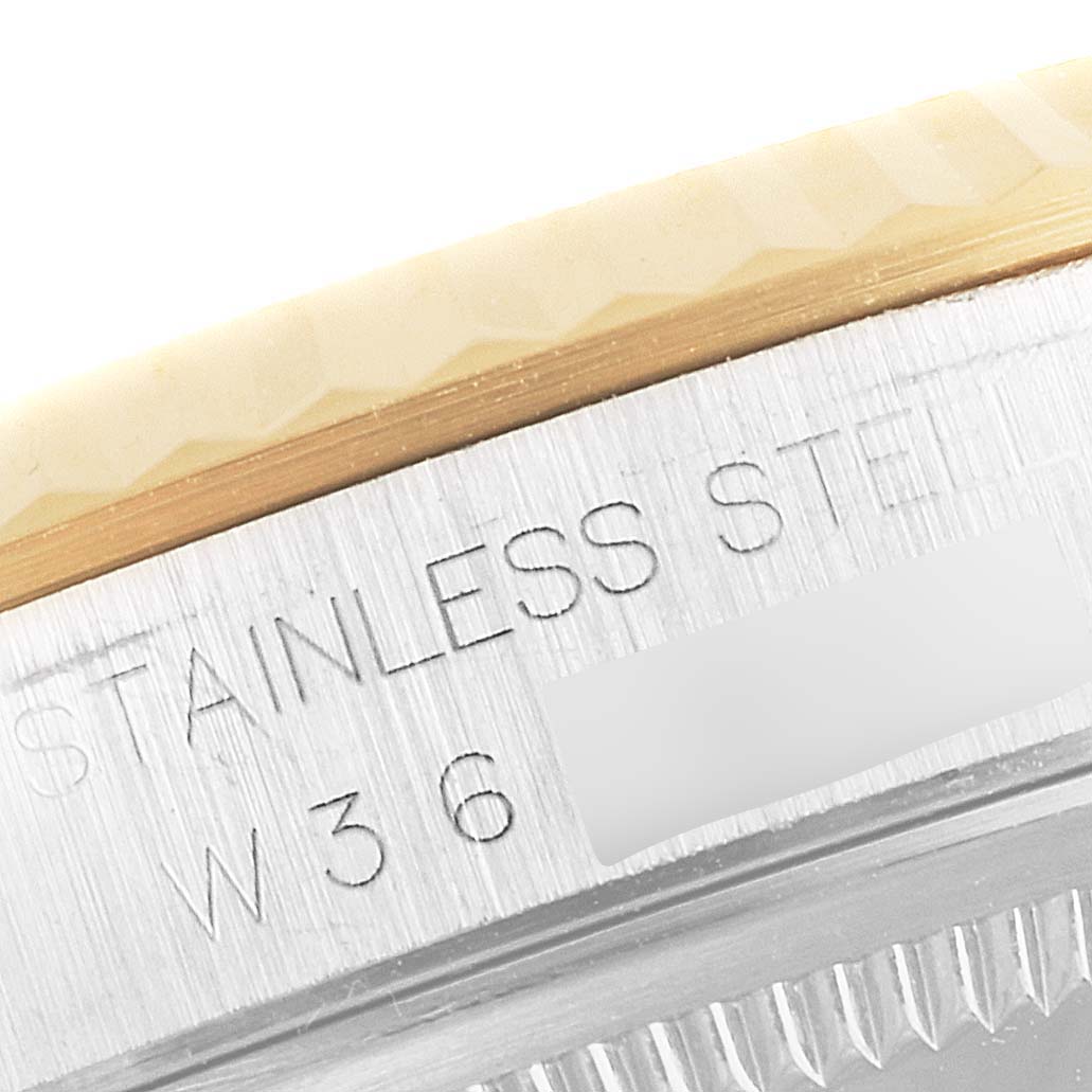 The image shows a close-up of the case edge and part of the bezel of a Rolex Datejust 16233 Men's Steel and Gold (two tone) White Dial 16233 Men's Steel and Gold (two tone) White Dial, highlighting the "Stainless Steel" engraving.