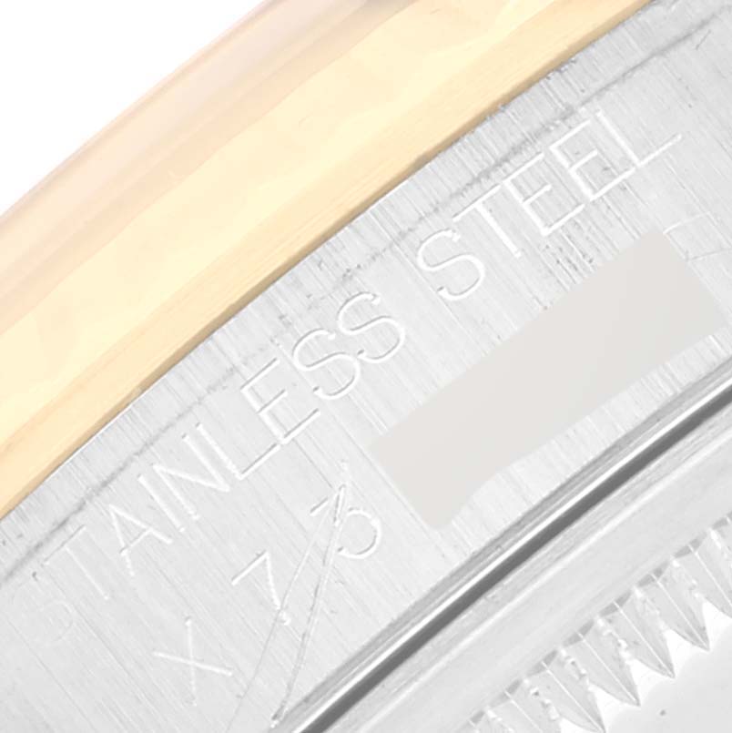 This is a close-up image of the bezel and part of the rehaut of a Rolex Datejust 16233 Men's Steel and Gold (two tone) White Dial 16233 Men's Steel and Gold (two tone) White Dial watch, showing the "STAINLESS STEEL" engraving.
