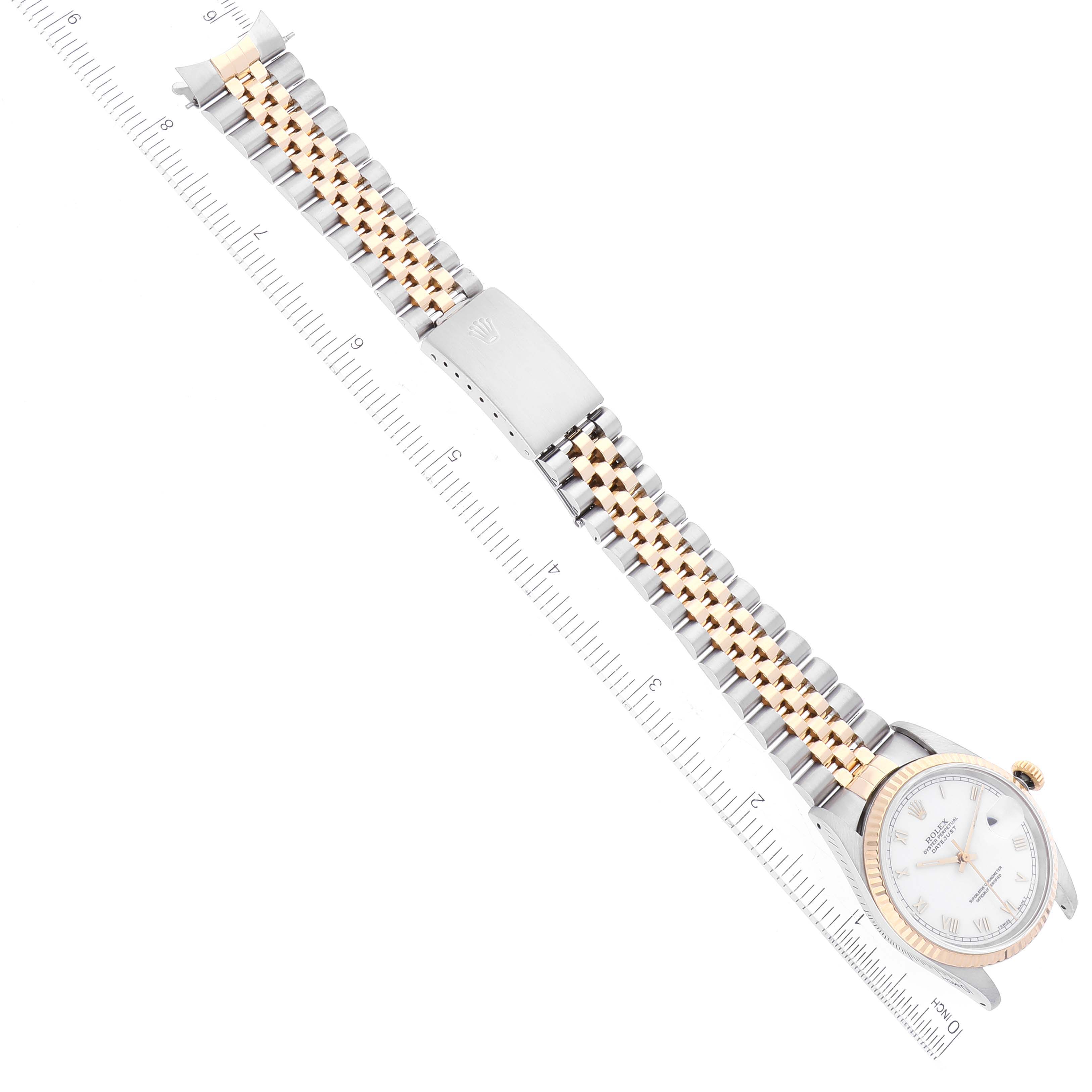 This image shows a Rolex Datejust 16233 Men's Steel and Gold (two tone) White Dial 16233 Men's Steel and Gold (two tone) White Dial watch laid out flat, highlighting its dial, bracelet, and clasp with a ruler for scale.