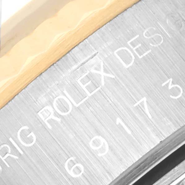 This image shows a close-up of the serial number engraving on the side of a Rolex Datejust 69173 Women's Steel and Gold (two tone) Blue Dial 69173 Women's Steel and Gold (two tone) Blue Dial watch case.