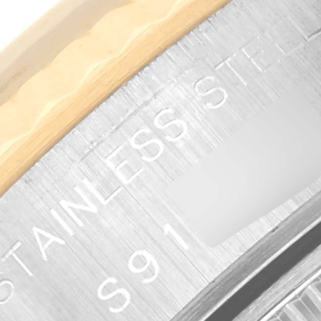 The image shows a close-up of the side engraving on the stainless steel and gold bezel of a Rolex Datejust 69173 Women's Steel and Gold (two tone) Blue Dial 69173 Women's Steel and Gold (two tone) Blue Dial watch.