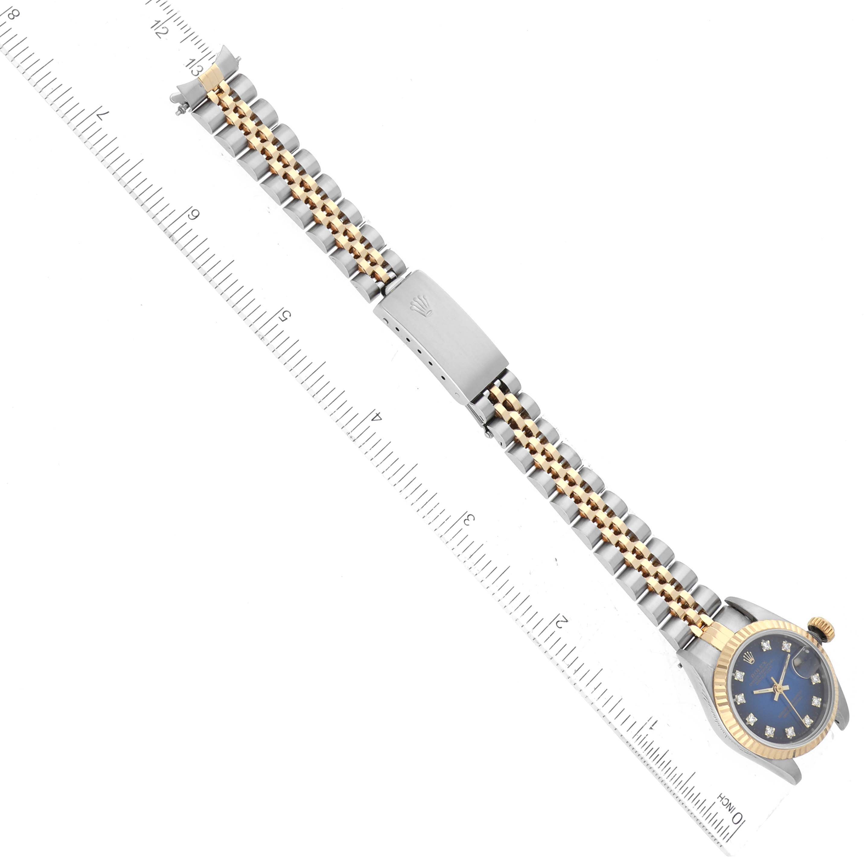 The image shows a Rolex Datejust 69173 Women's Steel and Gold (two tone) Blue Dial 69173 Women's Steel and Gold (two tone) Blue Dial watch laid flat, focusing on its bracelet and clasp, along with a full view of the watch face.
