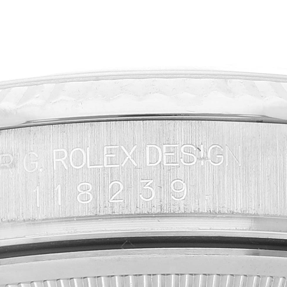 The image shows a close-up view of the side of a Rolex President 118239 Men's White Gold Silver Dial 118239 Men's White Gold Silver Dial model watch, focusing on the engraved serial number and design inscription.