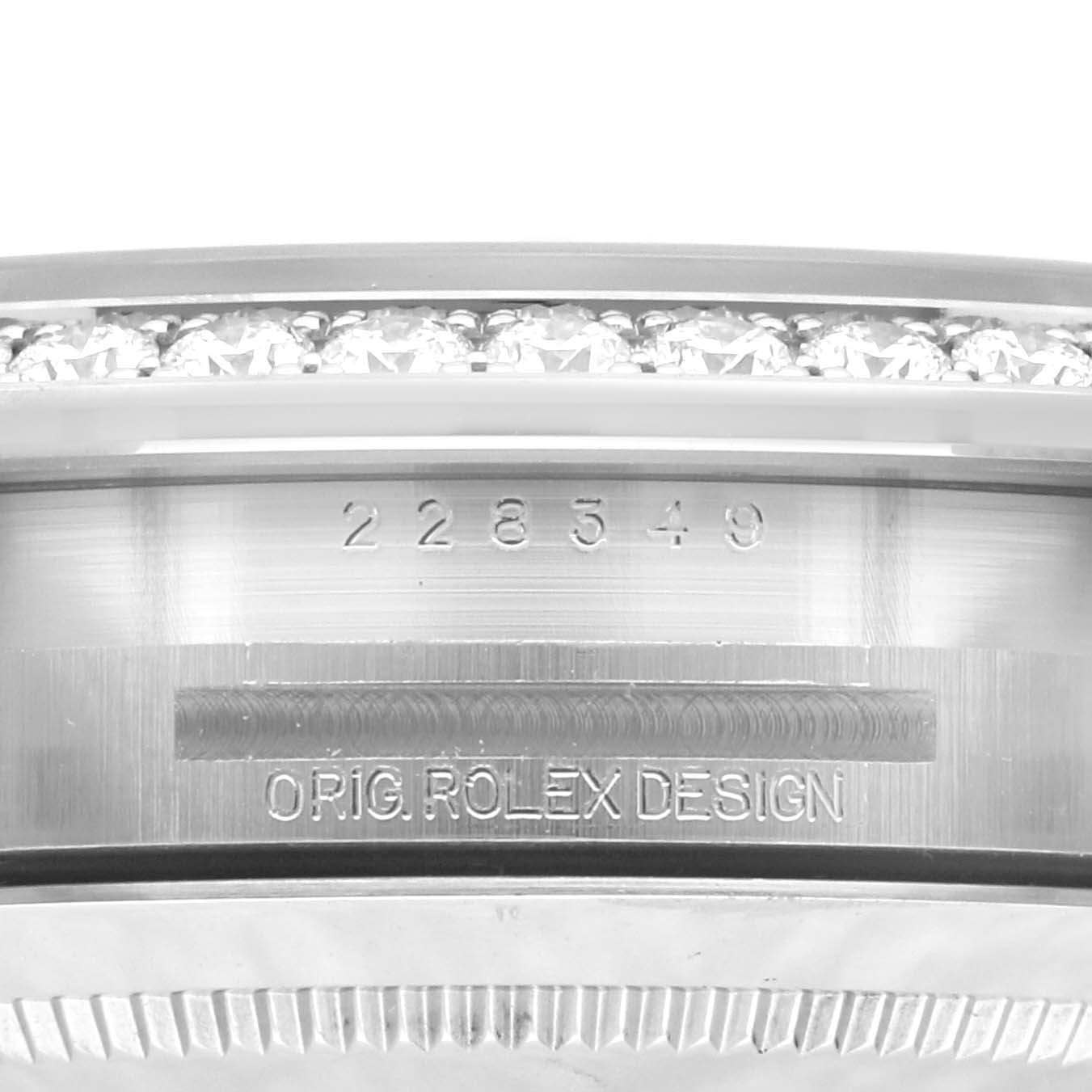This close-up image shows the side view of a Rolex President 228349RBR Men's White Gold Green Dial 228349RBR Men's White Gold Green Dial model watch with serial number and "ORIG ROLEX DESIGN" engraving.