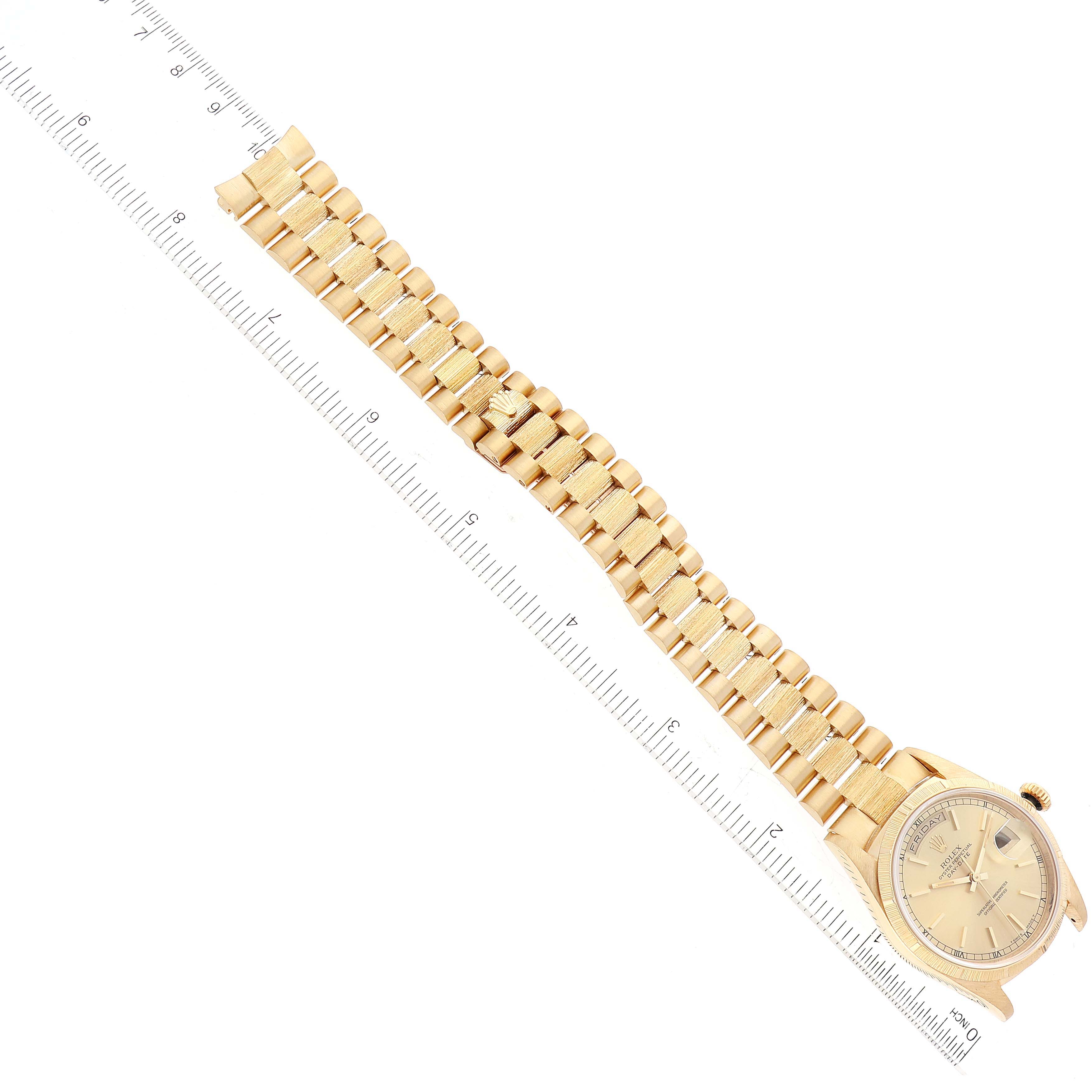 The image shows the Rolex President 18248 Men
s Yellow Gold Champagne Dial 18248 Men
s Yellow Gold Champagne Dial watch from an aerial view, highlighting the face and the full length of the gold bracelet.