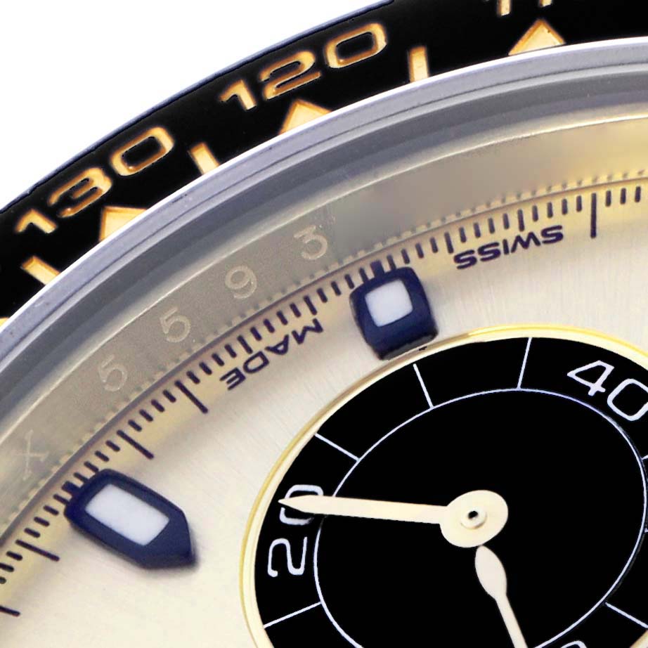 The image shows a close-up of the Rolex Daytona 73019 Men
s Yellow Gold Champagne Dial watch face, featuring the dial, markers, and part of the bezel.