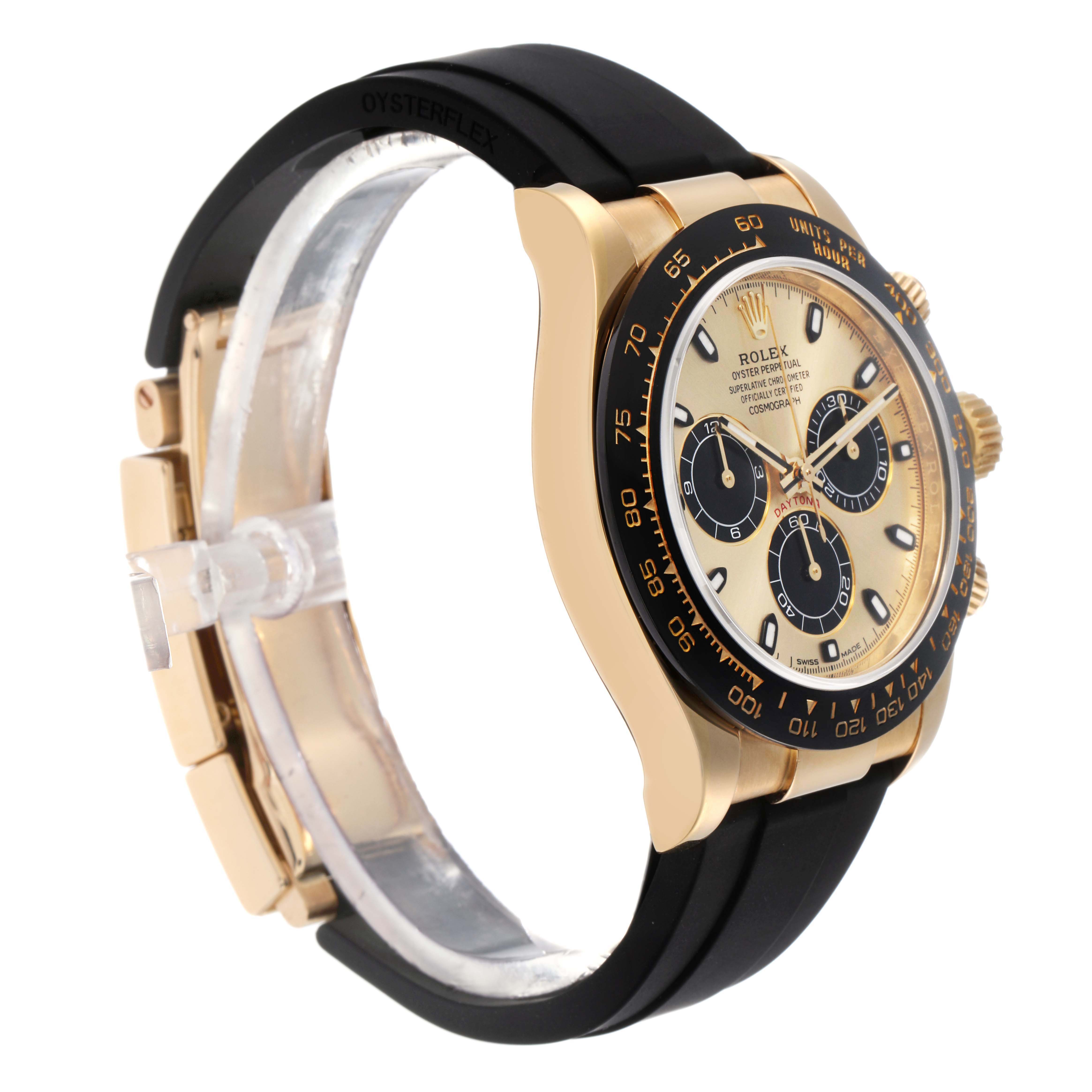 The Rolex Daytona 73019 Men
s Yellow Gold Champagne Dial watch is shown at a side angle, highlighting its gold case, black bezel, and black Oysterflex strap.