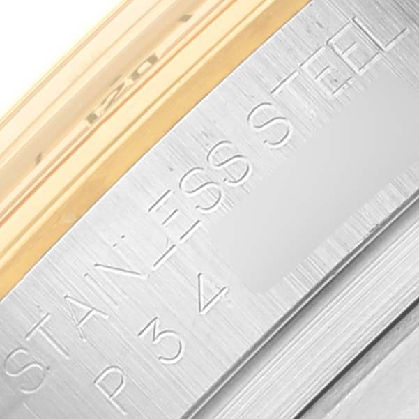This close-up image shows part of the stainless steel bezel with "STAINLESS STEEL" engraved on it for a Rolex Daytona 116523 Men's Steel and Gold (two tone) White Dial 116523 Men's Steel and Gold (two tone) White Dial watch.