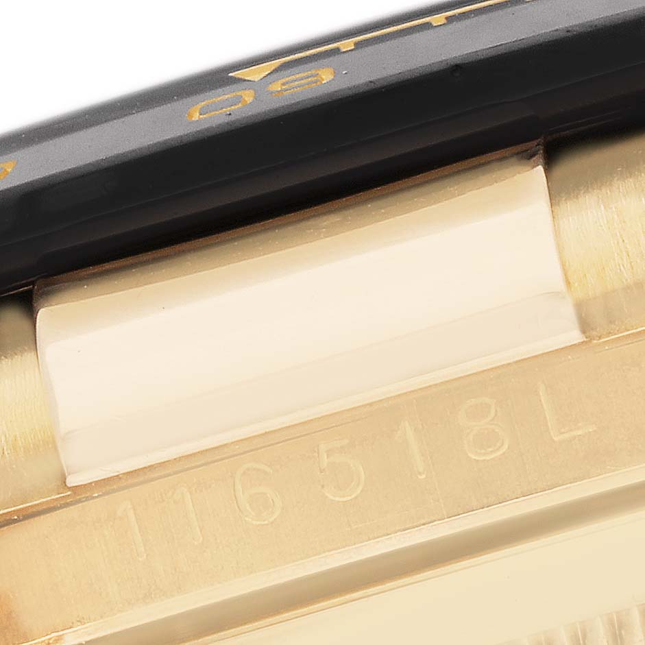 The image shows a close-up angle of a Rolex Daytona 116518LN Men
s Yellow Gold Champagne Dial
s bezel and case, highlighting the model number engraving.