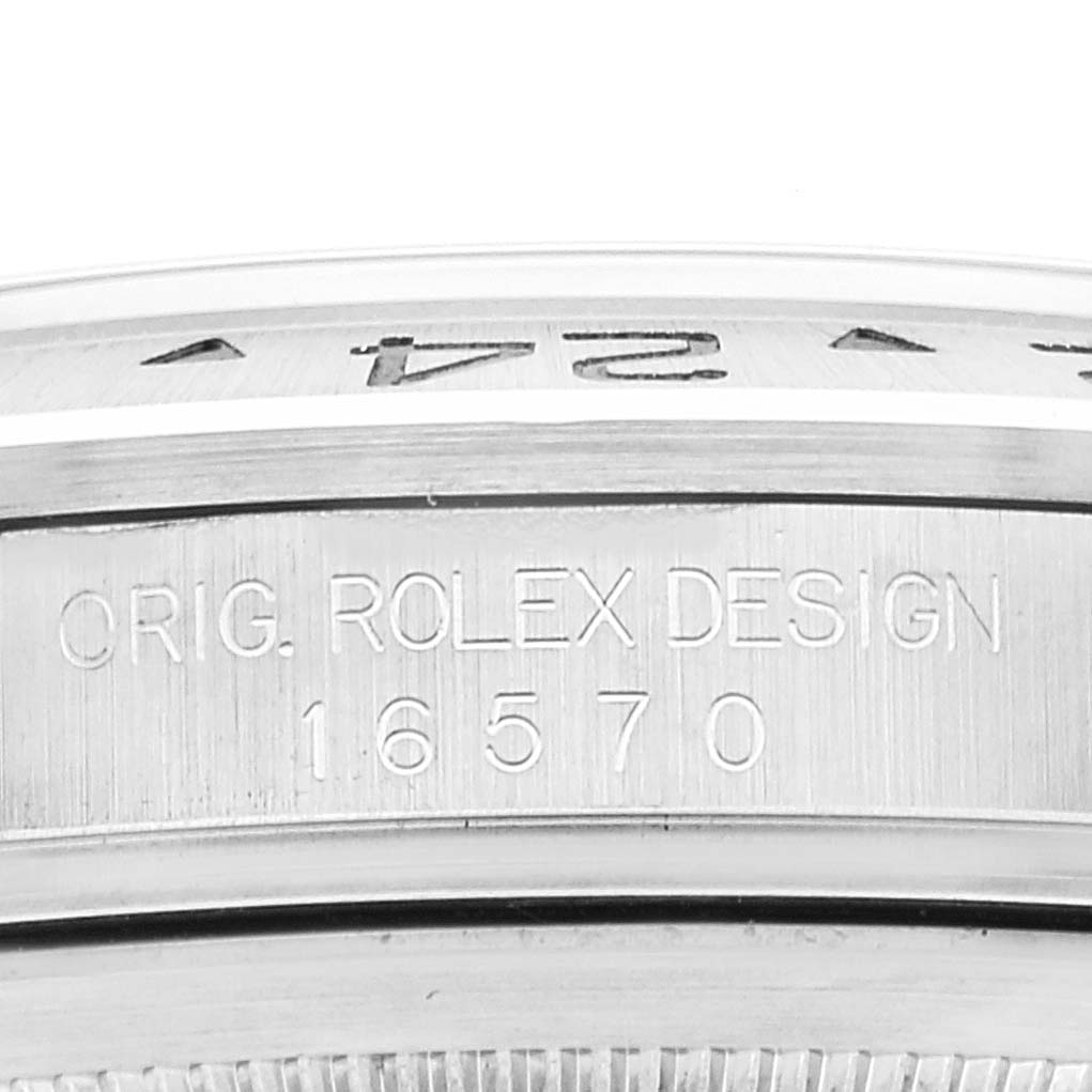 This image shows a close-up of the case side of a Rolex Explorer 16570 Men
s Stainless Steel White Dial 16570 Men
s Stainless Steel White Dial, revealing the serial number and "ORIG. ROLEX DESIGN" engraving.