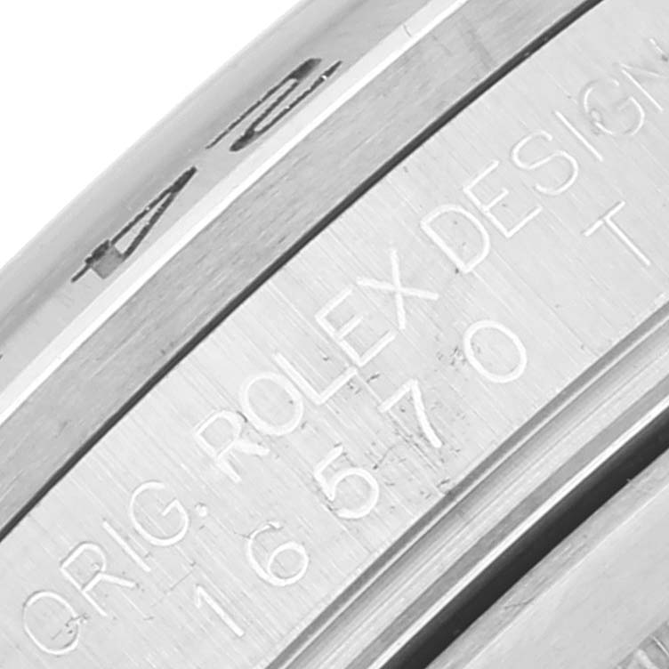 This image shows a close-up of the engraved serial number and "ROLEX DESIGN" text on the side of a Rolex Explorer 16570 Men's Stainless Steel Black Dial 16570 Men's Stainless Steel Black Dial watch.