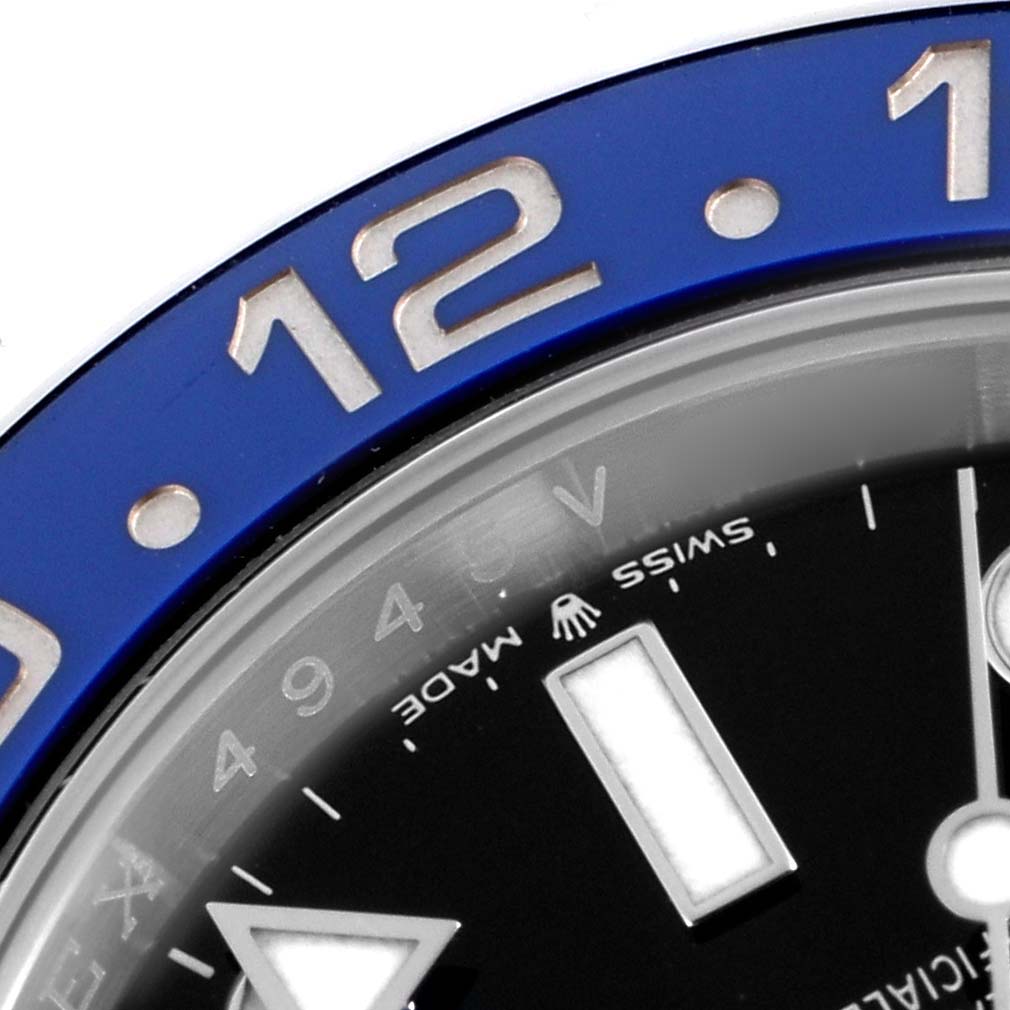 The image shows a close-up of the bezel and part of the dial of a Rolex GMT-Master 126710 Men
s Stainless Steel Black Dial, highlighting the hour markers and "Swiss Made" text.