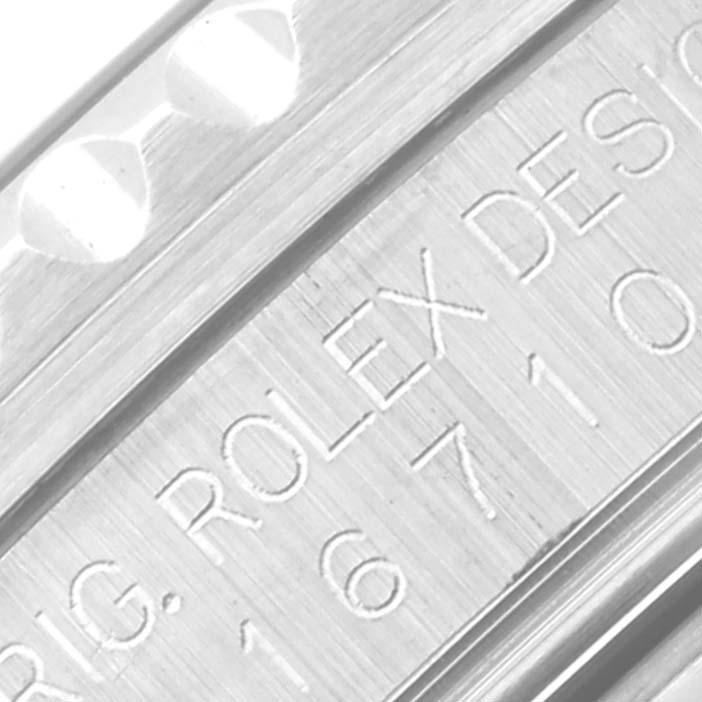 The image shows an angled close-up of the engraving on a Rolex GMT-Master 16710 Men's Stainless Steel Black Dial 16710 Men's Stainless Steel Black Dial watch.