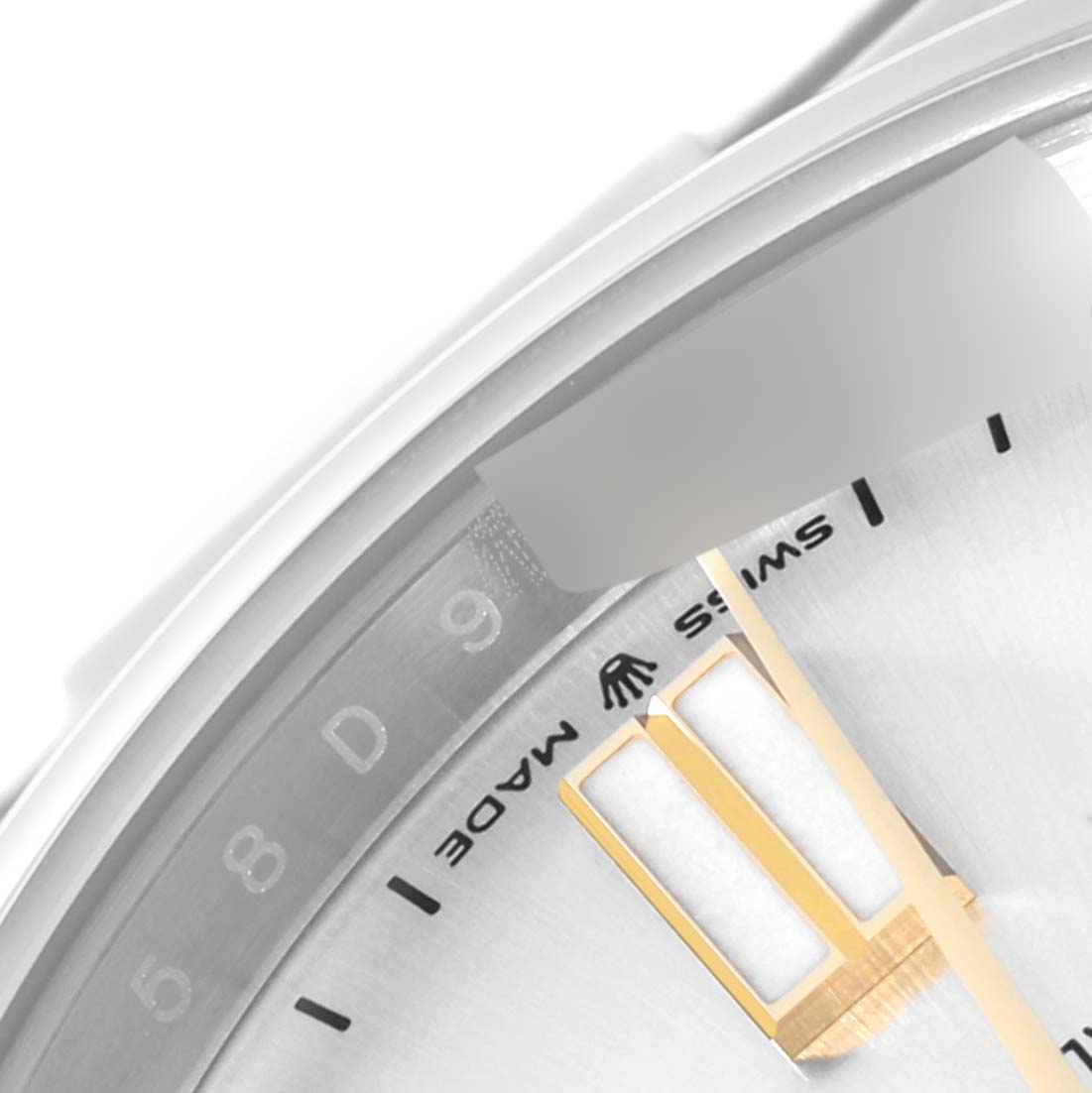 This image shows a close-up angle of the dial and hands of a Rolex Oyster Perpetual 124300 Men's Stainless Steel Silver Dial 124300 Men's Stainless Steel Silver Dial watch, highlighting the "Swiss Made" text.