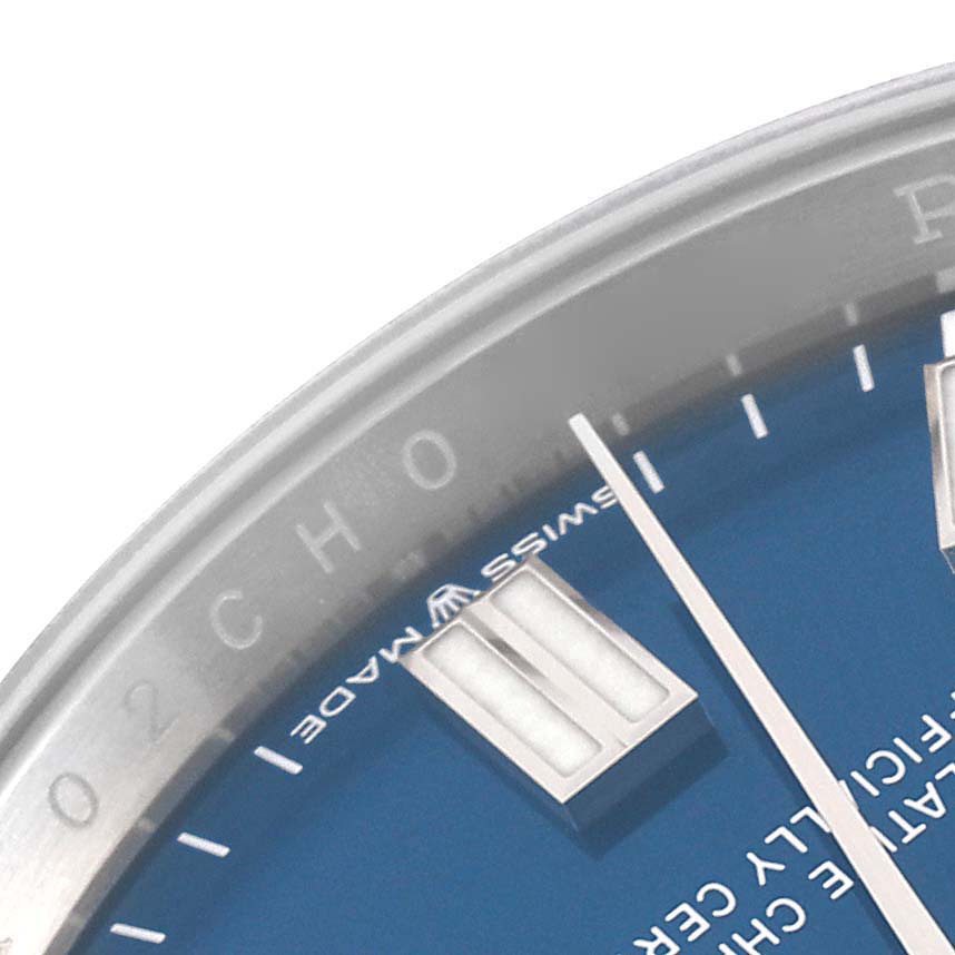 The image shows a close-up of the dial, markers, and part of the bezel of a Rolex Oyster Perpetual 126000 Men
s Stainless Steel Blue Dial 126000 Men
s Stainless Steel Blue Dial watch.