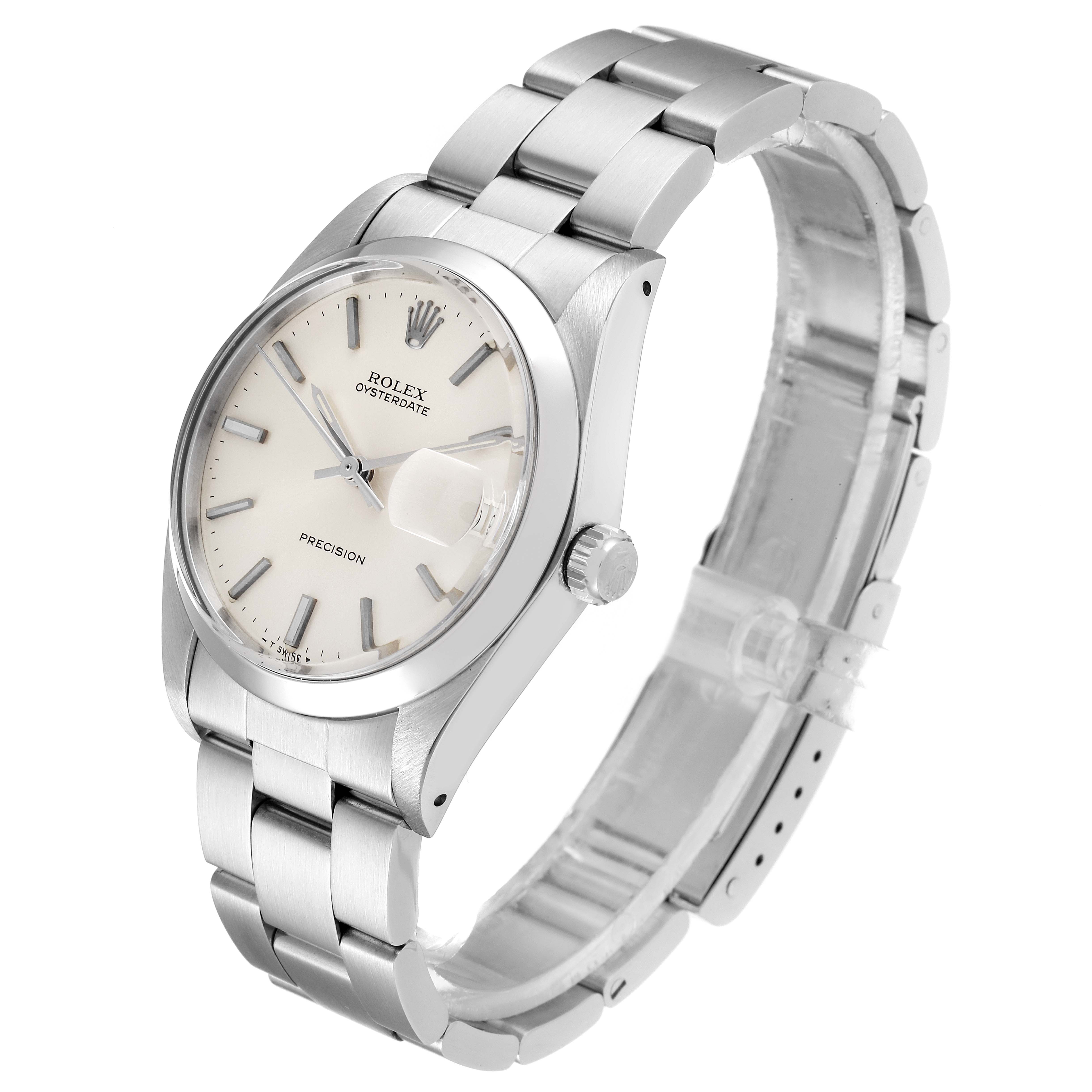 The Vintage Collection Rolex watch is shown at an oblique angle, highlighting its face, case, crown, and bracelet.