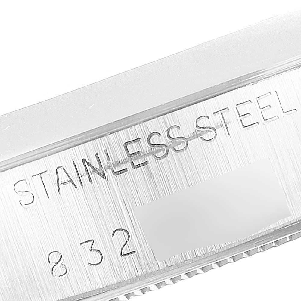 A close-up view of the case back edge of the Vintage Collection model by Rolex, showing "STAINLESS STEEL" and part of its serial number.