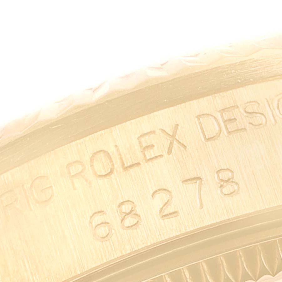 The image shows a close-up of the engraving on the side of the case of a Rolex President 68278 Women's Yellow Gold Champagne Dial 68278 Women's Yellow Gold Champagne Dial model watch.