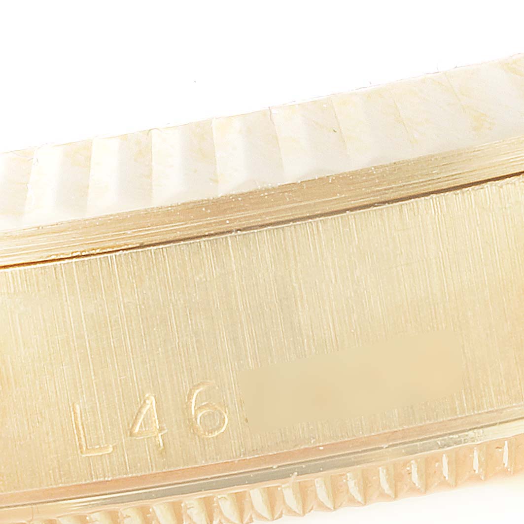 This image shows a close-up of the side of a Rolex President 68278 Women's Yellow Gold Champagne Dial 68278 Women's Yellow Gold Champagne Dial model watch, highlighting the serial number area and fluted bezel.
