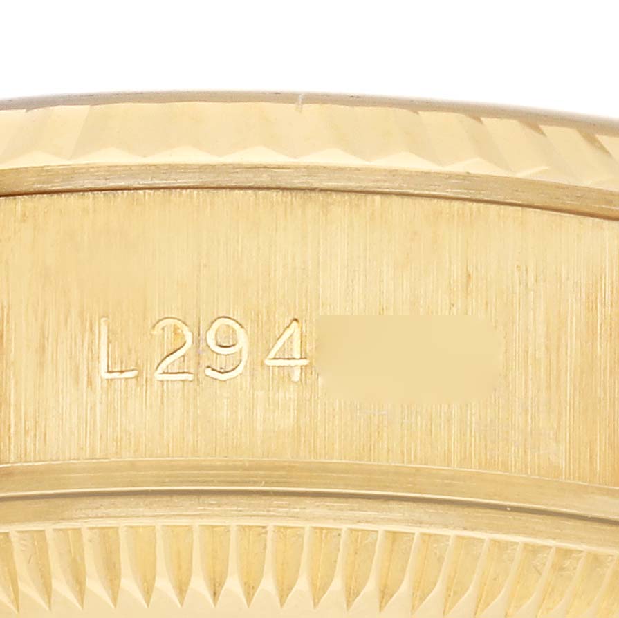 This image shows a close-up of the serial number on the side case of a Rolex President 69178 Women's Yellow Gold Champagne Dial 69178 Women's Yellow Gold Champagne Dial model watch.