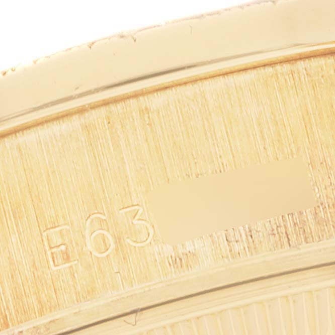 The close-up image shows part of the bezel with serial number engraving of a Rolex President 69288 Women's Yellow Gold Champagne Dial 69288 Women's Yellow Gold Champagne Dial model watch.