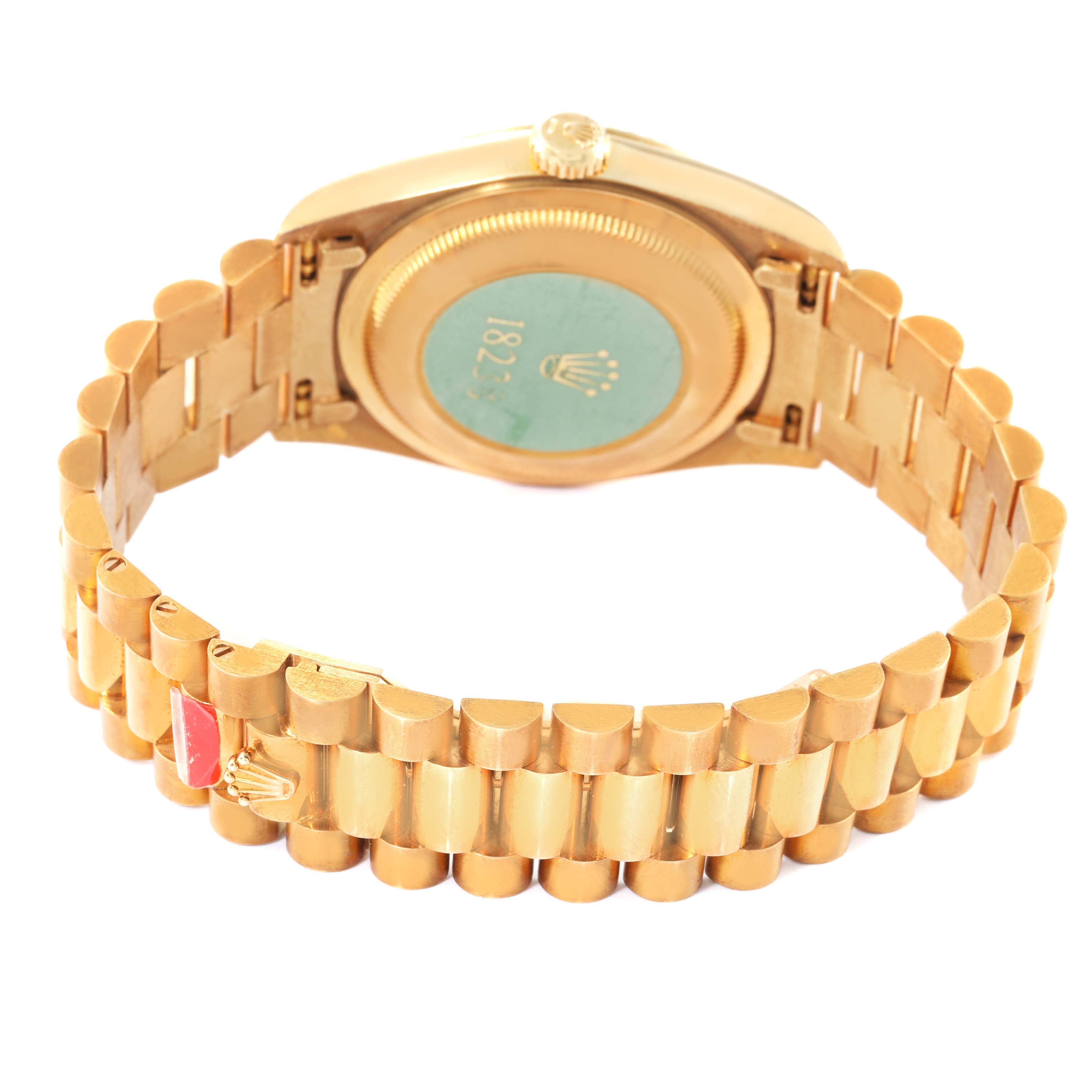 The image shows the back view of a President model Rolex watch, including its gold case and bracelet.