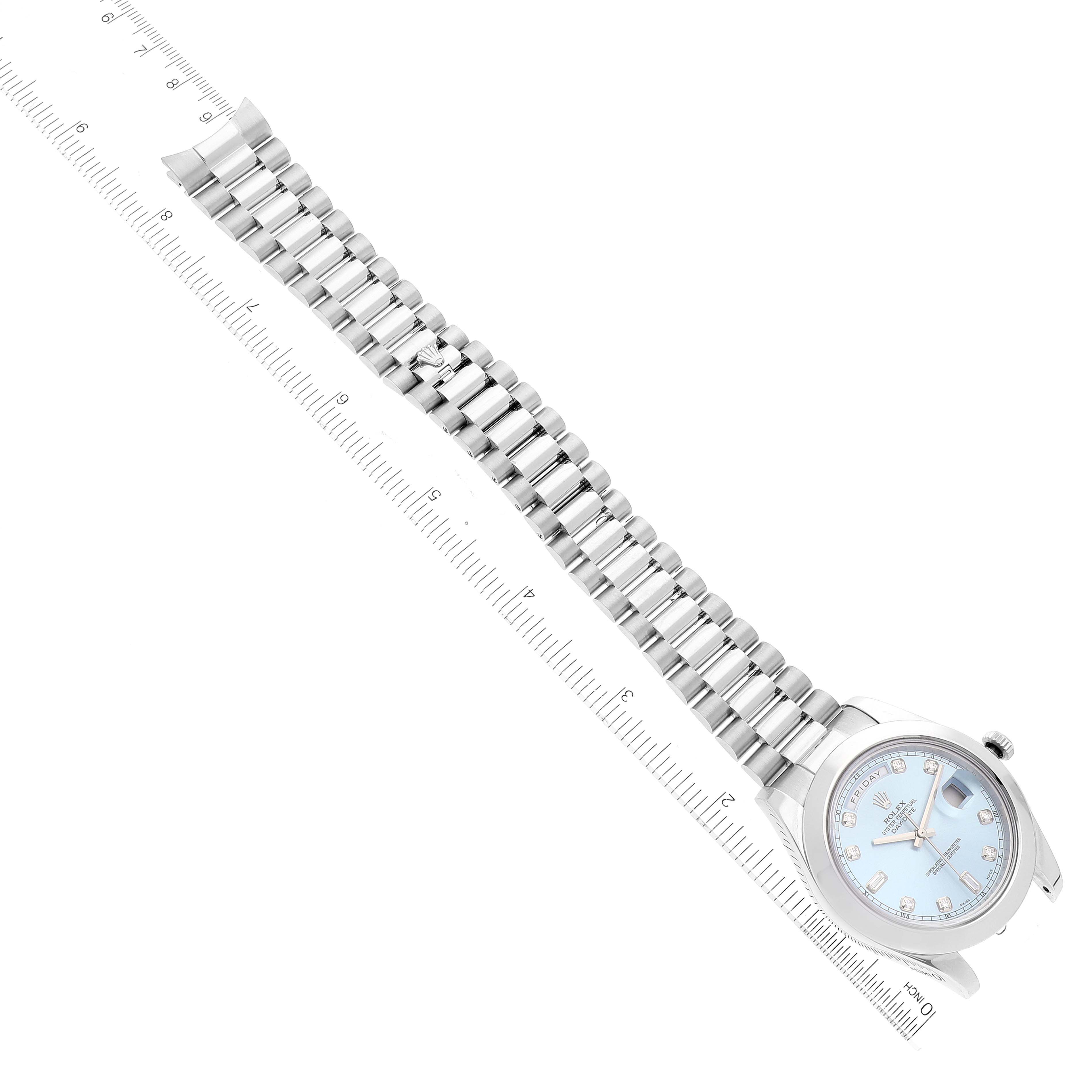 The image shows the Rolex President 218206 Men's Platinum Blue Dial 218206 Men's Platinum Blue Dial model watch lying flat next to a ruler, highlighting the full watch band and face.