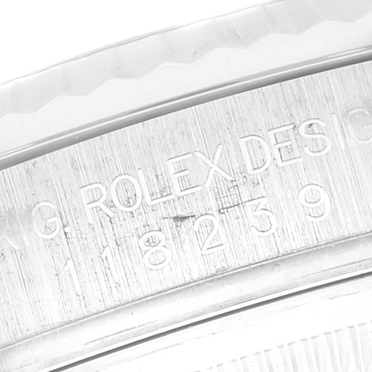 This close-up image shows part of the engraved inner bezel of a Rolex President 118239 Men's White Gold Silver Dial 118239 Men's White Gold Silver Dial model watch.