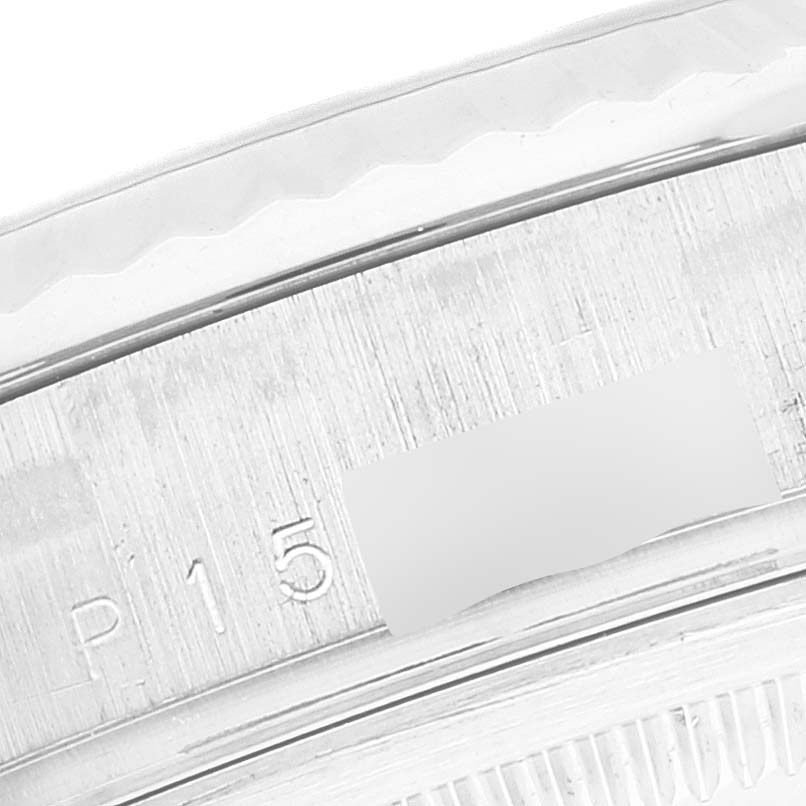 This image shows a close-up of the side of the case of the Rolex President 118239 Men's White Gold Silver Dial 118239 Men's White Gold Silver Dial model watch with visible serial numbers.