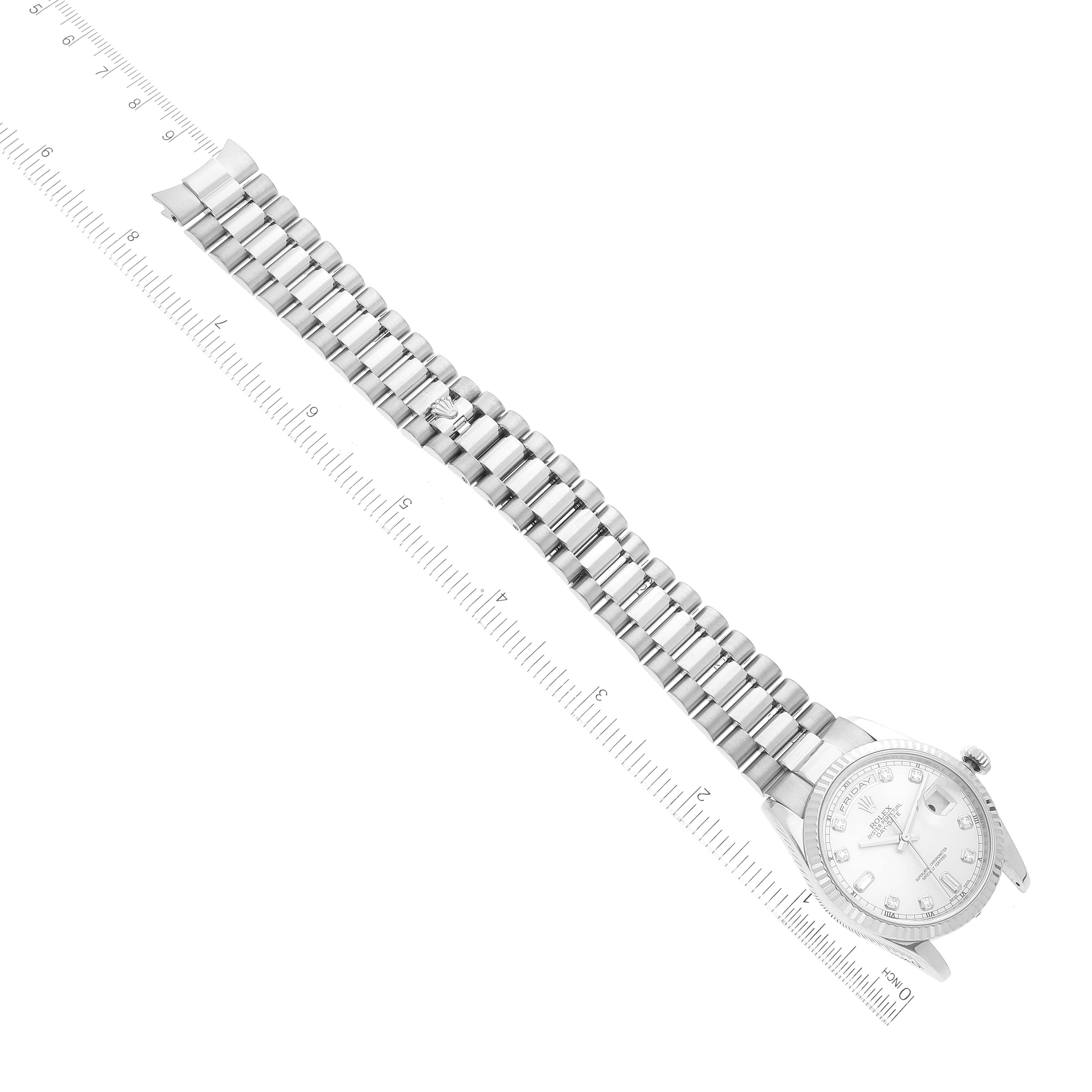 The Rolex President 118239 Men's White Gold Silver Dial 118239 Men's White Gold Silver Dial model watch is shown at a slightly tilted angle, displaying its full bracelet and face next to a measuring ruler.