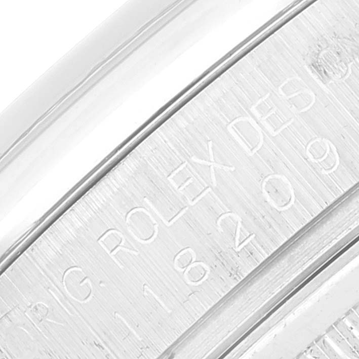 This close-up shows the engraved inner bezel of the Rolex President 118209 Men's White Gold Silver Dial 118209 Men's White Gold Silver Dial model watch.