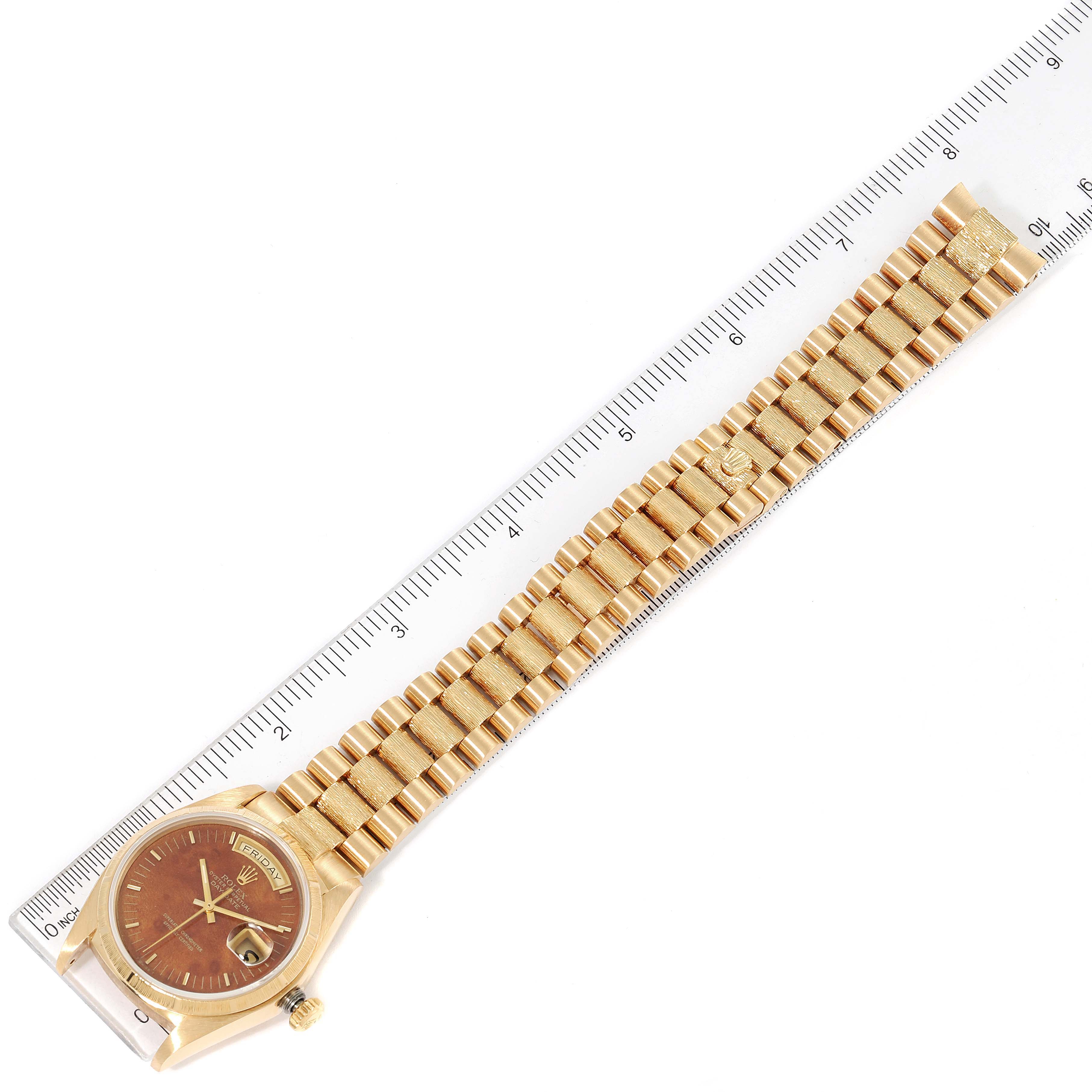 The Rolex President 18038 Men's Yellow Gold Brown Dial 18038 Men's Yellow Gold Brown Dial model watch is shown flat, displaying the face, band, and side, with a ruler for scale.