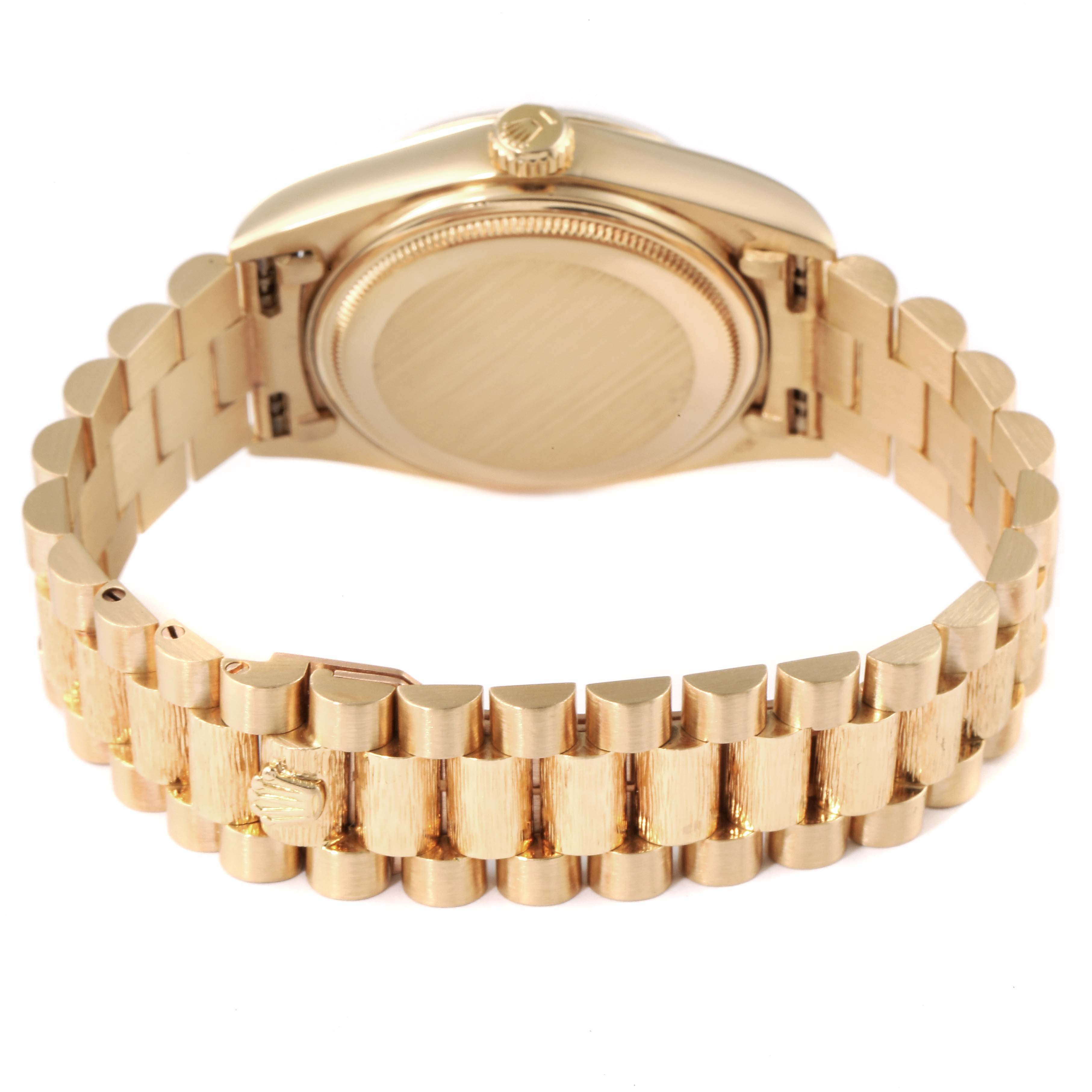 This image shows the backside of a Rolex President 18038 Men's Yellow Gold Brown Dial 18038 Men's Yellow Gold Brown Dial model watch, highlighting its case back and President bracelet.