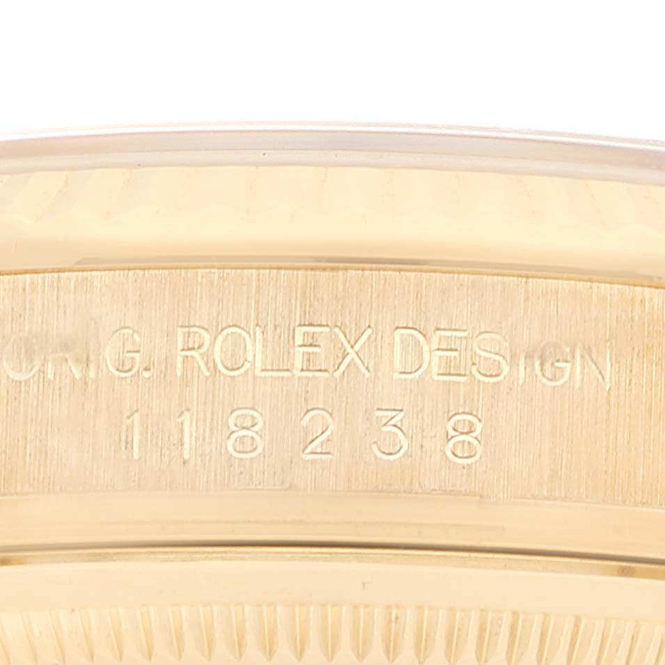 This image shows the Rolex President 118238 Men
s Yellow Gold Champagne Dial 118238 Men
s Yellow Gold Champagne Dial model
s case side with inscriptions and the model number "118238."