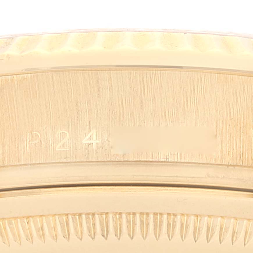 This image shows a close-up of the engraved bezel and case of a Rolex President 118238 Men
s Yellow Gold Champagne Dial 118238 Men
s Yellow Gold Champagne Dial model watch.